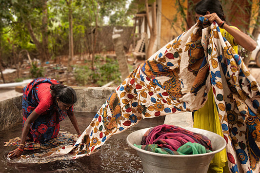 Traditional Kalamkari saree making process showing charcoal sketching, bamboo pen outlining, and natural dyeing techniques in South India